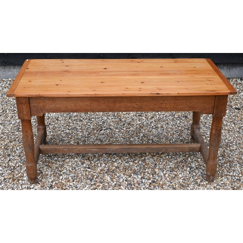 200 - A pine farmhouse kitchen dining table with cleated rectangular top on turned supports, 154 x 74 x 76... 