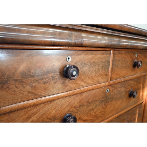 202 - A large Victorian country house figured mahogany chest with shallow cavetto drawer over two short an... 