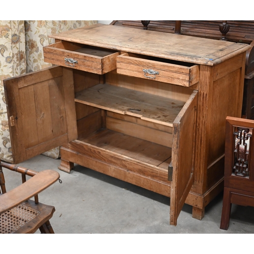 205 - An antique provincial oak dresser base with two drawers over panelled cupboardsmissing one bracket f... 