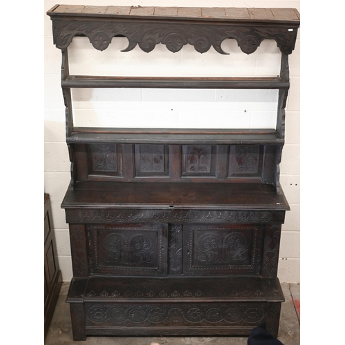 207 - #An antique Continental carved oak dresser in dark stained finish, 136 cm wide x 55 cm deep x 200 cm... 