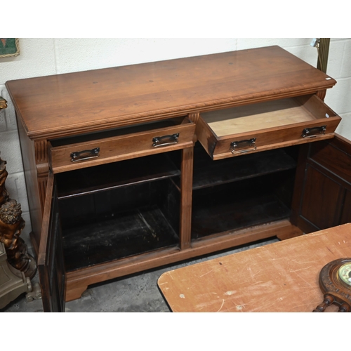 210 - A stained hardwood sideboard or dresser base with two drawers over panelled cupboards on bracket fee... 