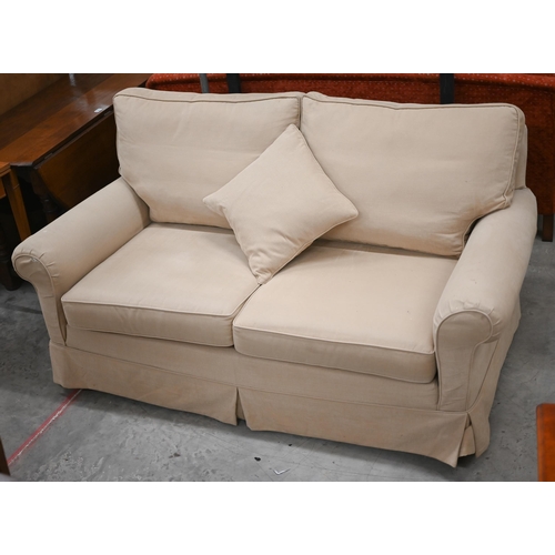 218 - A Duresta two seater scroll-arm sofa in beige fabric with loose covers, 178 x 96 x 90 cm high