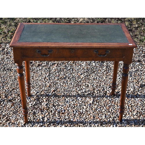 228 - A 19th century walnut writing table with green leather top, single frieze drawer and turned supports... 