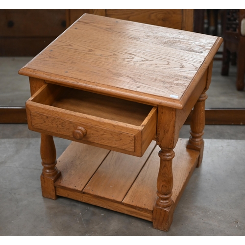 229 - #A light oak bedside/lamp table with drawer on turned supports and open undertier, 54 cm wide x 46 c... 