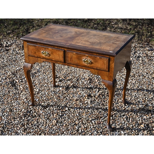 A walnut Queen Anne style crossbanded two-drawer hall table on cabriole supports a/f, 90 x 52 x 74 cm high