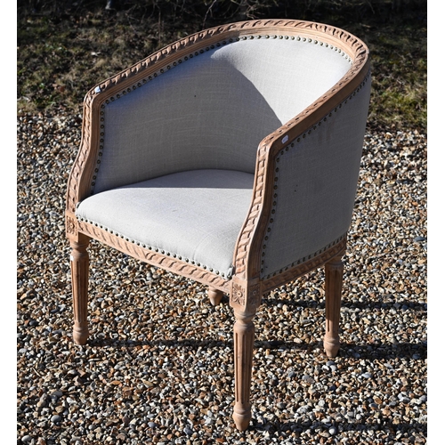 239 - A French limed and carved hardwood tub armchair with studded pale grey upholstery