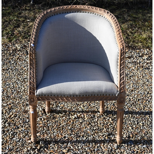 239 - A French limed and carved hardwood tub armchair with studded pale grey upholstery