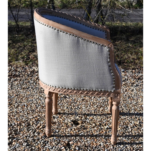 239 - A French limed and carved hardwood tub armchair with studded pale grey upholstery