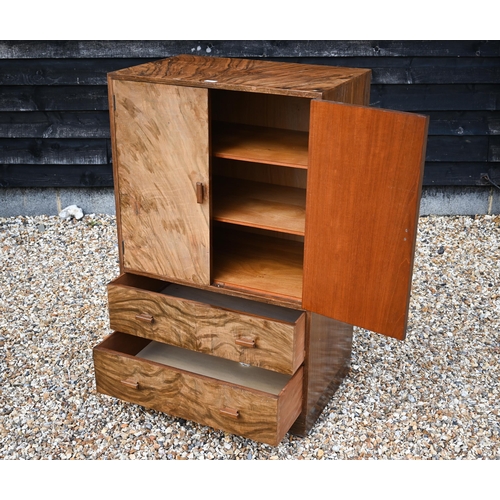 24 - An Art Deco period walnut press cupboard over two graduated drawers, on a plinth base, 75 cm x 50 cm... 