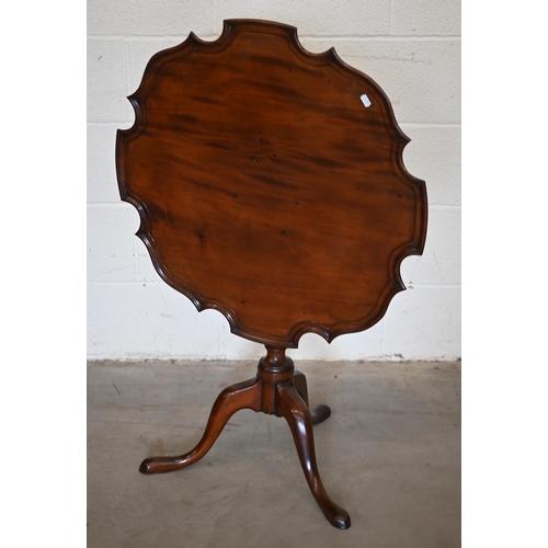 253 - A 19th century mahogany occasional table with scalloped tilt-top on turned column and triform suppor... 