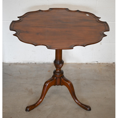 253 - A 19th century mahogany occasional table with scalloped tilt-top on turned column and triform suppor... 