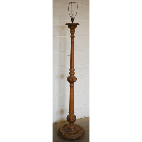 255 - A turned carved and fluted hardwood standard lamp with pleated silk shade