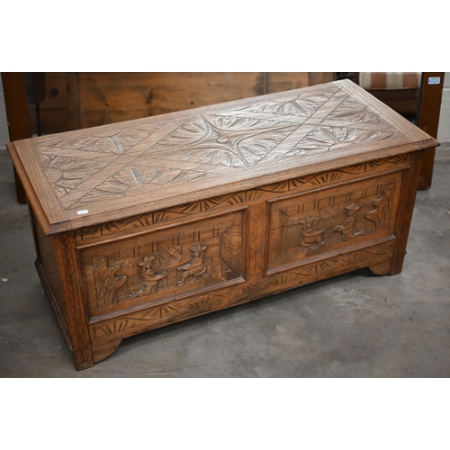 257 - An elm blanket chest/coffer of panelled construction carved with kneeling and seated figures, 106 x ... 