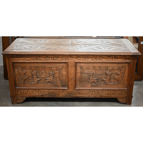 257 - An elm blanket chest/coffer of panelled construction carved with kneeling and seated figures, 106 x ... 