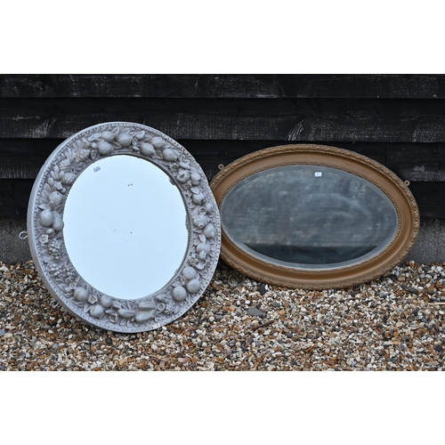 259 - #A circular wall mirror in grey painted (overgilt) wooden and gesso frame moulded with fruit to/w a ... 