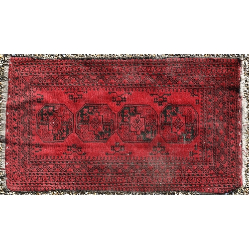 265 - A worn Afghan gul design red ground rug, 200 x 120 cm