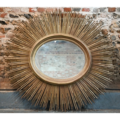 269 - A large bevelled oval wall mirror in 'sunburst' gilt frame, 135 x 145 cm