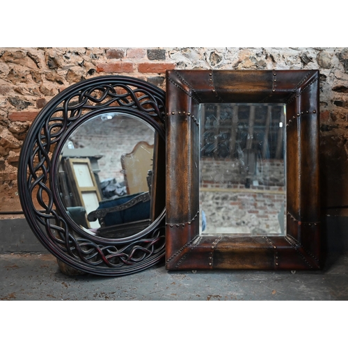 270 - A bevelled rectangular mirror in moulded simulated leather frame, 110 x 88 cm to/w bevelled circular... 