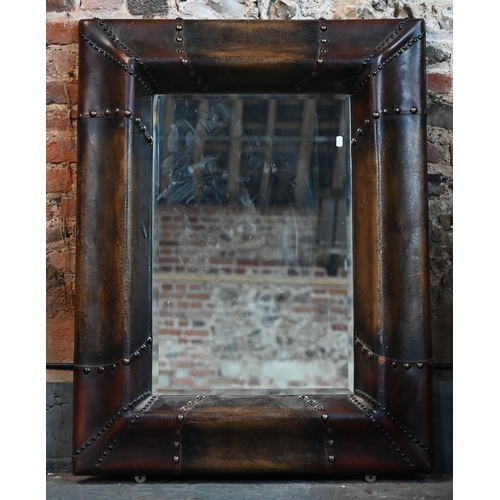 270 - A bevelled rectangular mirror in moulded simulated leather frame, 110 x 88 cm to/w bevelled circular... 