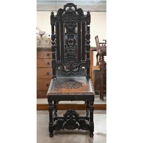 274 - A 19th century carved oak hall chair in the 17th century manner