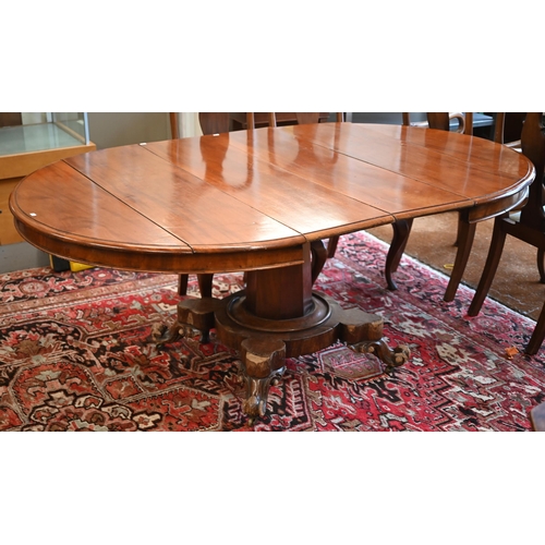 285 - A late 19th century mahogany extending circular dining table on tapering octagonal column and quadra... 