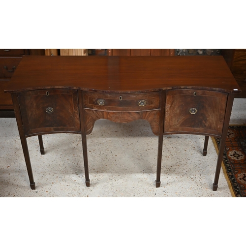 29 - #An antique mahogany serpentine front sideboard, centred by a drawer flanked by a cupboard and deep ... 
