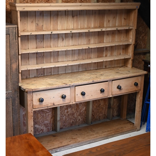 3 - A Victorian stripped pine kitchen dresser, the three tier tongue & grove backed rack over three ... 
