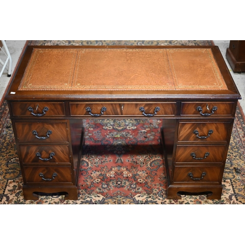 38 - A reproduction Victorian style mahogany twin pedestal desk, with gilt tooled green leather top over ... 