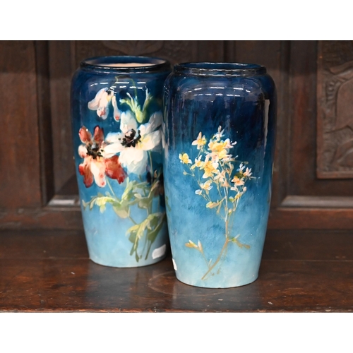 398 - A pair of Montigny-sur-Loing faience vases, painted with flowers on a blue ground, 22.5 cm high (2)