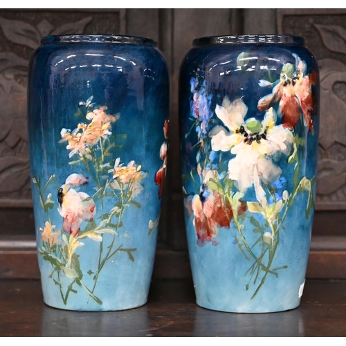 398 - A pair of Montigny-sur-Loing faience vases, painted with flowers on a blue ground, 22.5 cm high (2)