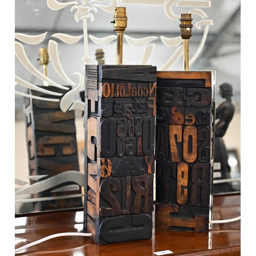 431 - Two table lamps constructed from carved wood printing-block letters, 51 cm high including fittings