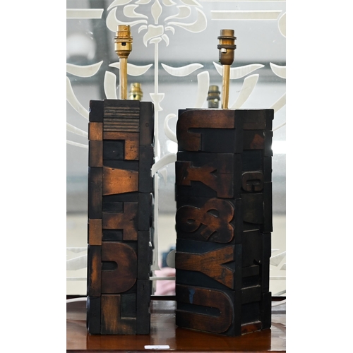 431 - Two table lamps constructed from carved wood printing-block letters, 51 cm high including fittings