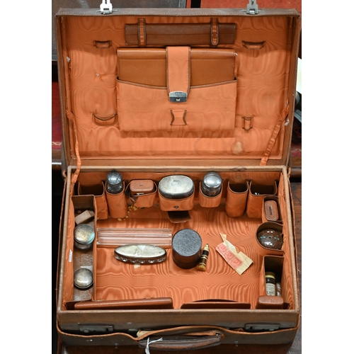 455 - A vintage pigskin toilet case partly-fitted, including some silver-mounted jars, etc with leather-tr... 