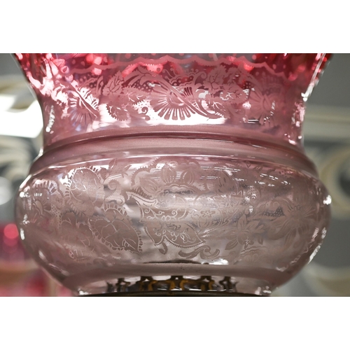 470 - A Victorian brass oil lamp on reeded column, with etched cranberry shade, 65 cm overall