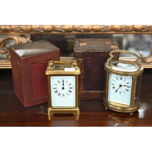 484 - Two vintage brass carriage clocks in leather travel cases