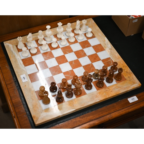 494 - An onyx and marble chessboard with chessmen