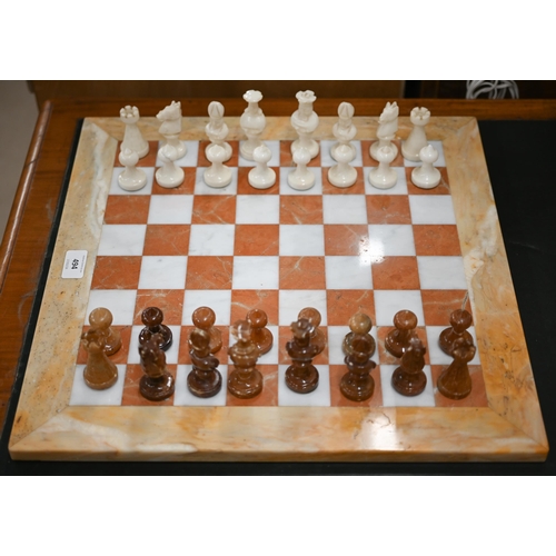 494 - An onyx and marble chessboard with chessmen