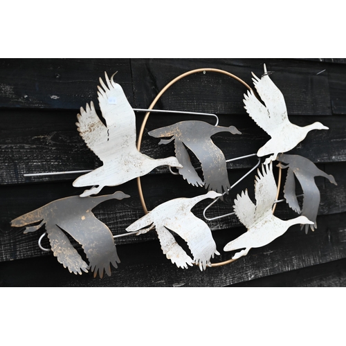 507 - A painted metal wall-ornament, geese flying in front of the moon, 58 x 106 cm