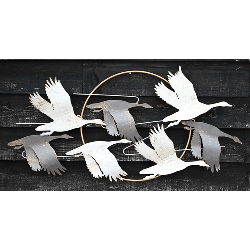 507 - A painted metal wall-ornament, geese flying in front of the moon, 58 x 106 cm