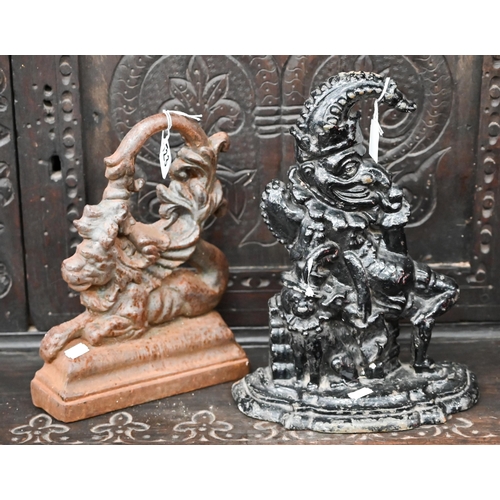 523 - Two Victorian cast iron doorstops - Mr Punch and Merlion (lion with fish's tail) (2)