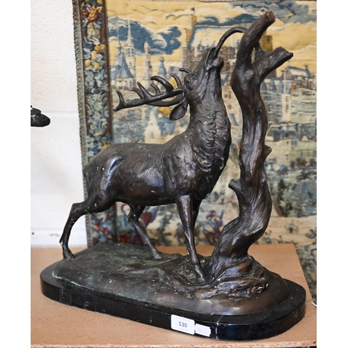 530 - A bronzed stag eating from a branch, 45 cm high