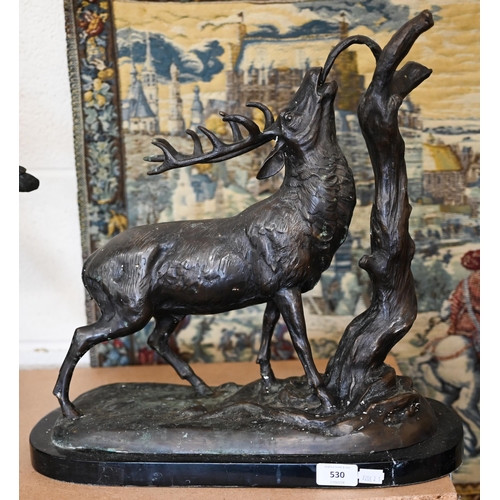 530 - A bronzed stag eating from a branch, 45 cm high