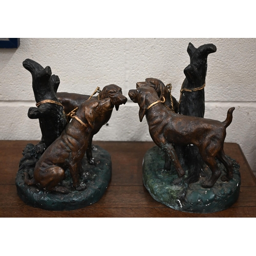 532 - Two painted and gilded bronze groups of gundogs, tied to a tree, signed 'Johnson' 32 cm high to/w a ... 