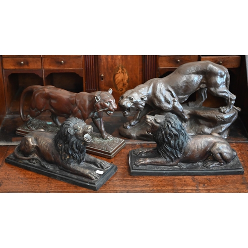 538 - Two bronzed recumbent lions, 36 cm long to/w two bronzed panthers - one signed 'Cartier' (4)