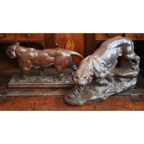 538 - Two bronzed recumbent lions, 36 cm long to/w two bronzed panthers - one signed 'Cartier' (4)