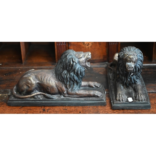 538 - Two bronzed recumbent lions, 36 cm long to/w two bronzed panthers - one signed 'Cartier' (4)