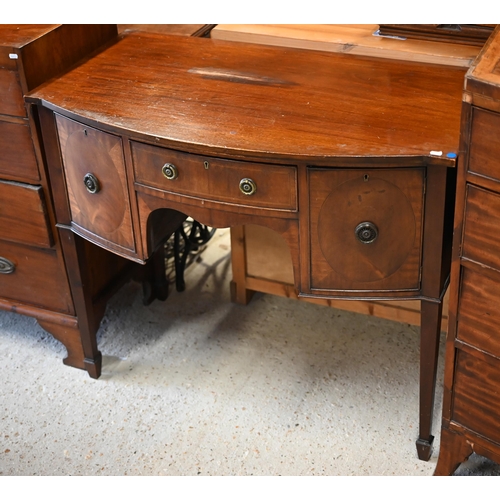 64 - An antique small mahogany bowfront sideboard, centred by a drawer flanked by a deep drawer and cupbo... 