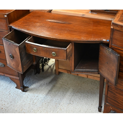 64 - An antique small mahogany bowfront sideboard, centred by a drawer flanked by a deep drawer and cupbo... 