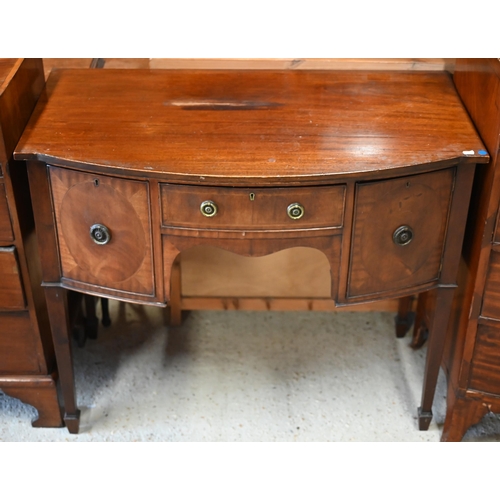 64 - An antique small mahogany bowfront sideboard, centred by a drawer flanked by a deep drawer and cupbo... 