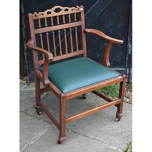 76 - A George III oak open armchair with spindle back and green leather seat, reduced in height